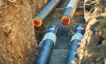 Underground insulated district heating and cooling pipes 