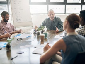 people in conversation in a research meeting