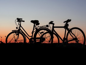 2 bicycles in front of a sunrise