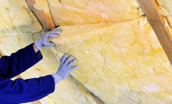 Contractor adding internal insulation to a roof