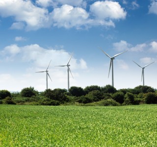 wind turbines in a field with clouds