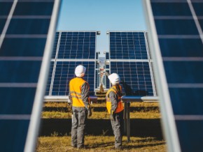 contractors assessing a solar panel