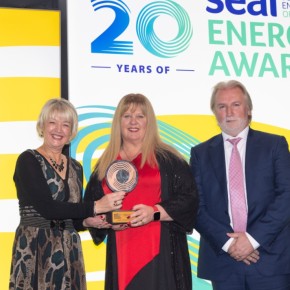 Three people with SEAI logo in the background. L-R: Marion O’Brien, Director of Corporate Services at SEAI presenting the Innovative Deployment of Renewable Energy Award to Michelle and Gareth McAllister of Ahascragh Distillers Ltd at SEAI Energy Awards 2023.