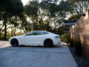 An electric vehicle charging in a driveway