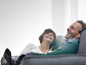 a couple relaxing on a couch in their home