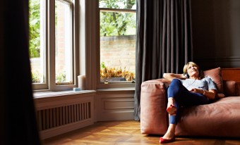 A woman relaxing on the couch in her home