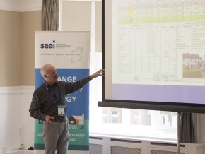 A man making a presentation in front of a screen