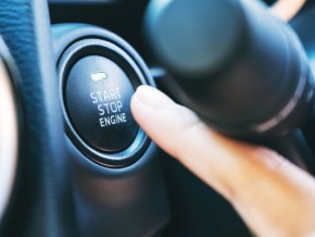 a person pressing the button to start an electric vehicle