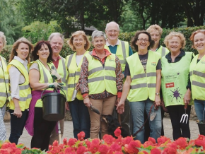 Members of the community in high vis vests gardening