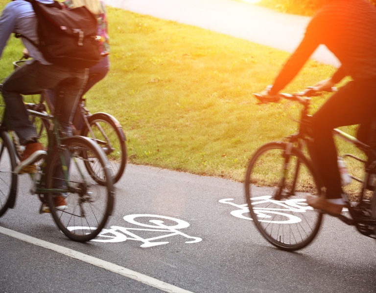 Three people cycling on a cycle path