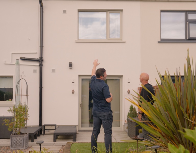 Pat Coyle, Churchfield Home Services, with homeowner John Brady, outside John's home.