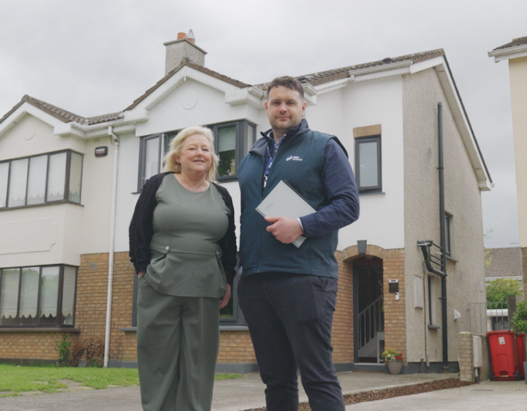 Martina standing outside her home with John from SSE Airtricity