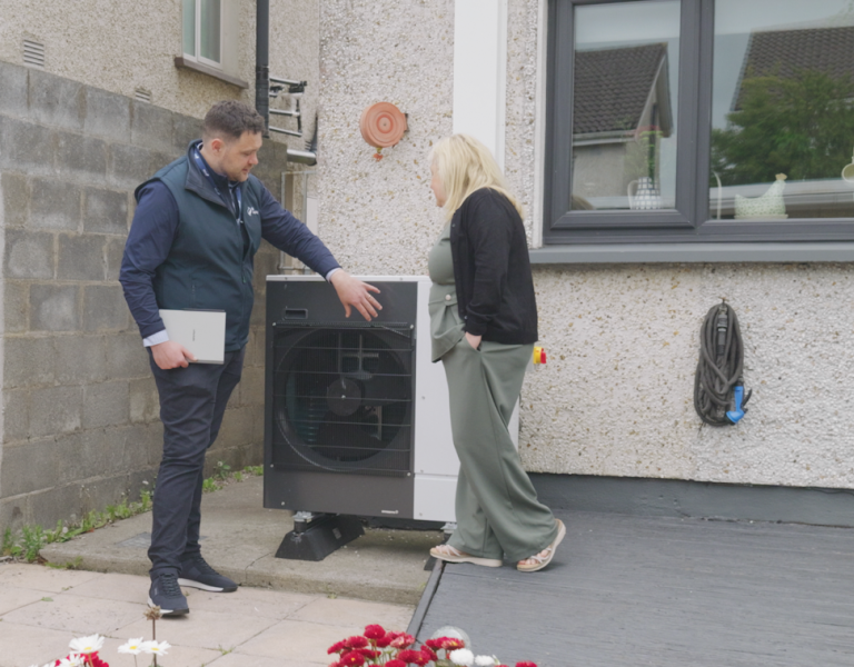 John and Martina looking at the heat pump