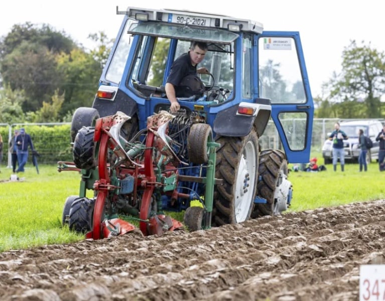 A blue tractor ploughing a field at the National Ploughing Championships 2026