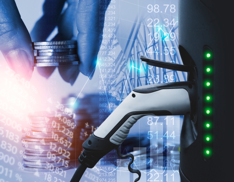 Picture of ev charger and a hand with money