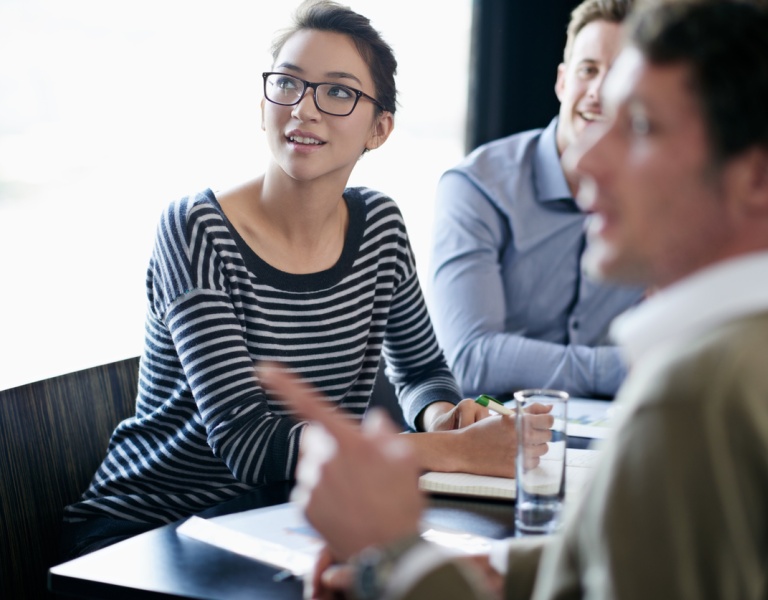 People engaged in discussion in a meeting
