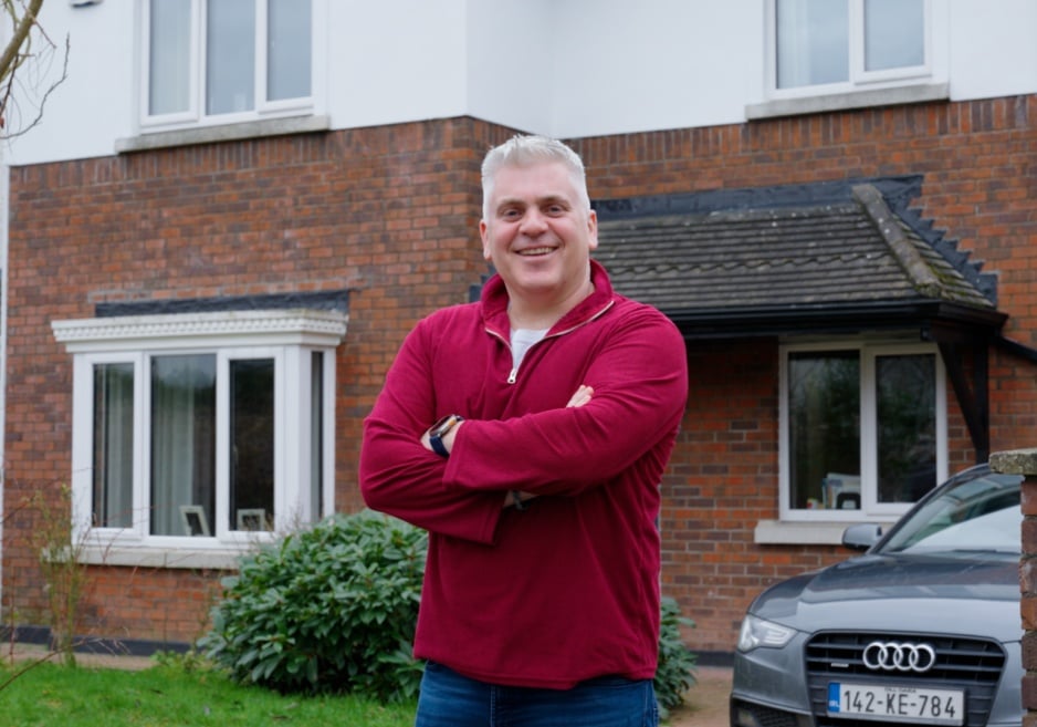 Man standing outside of his house