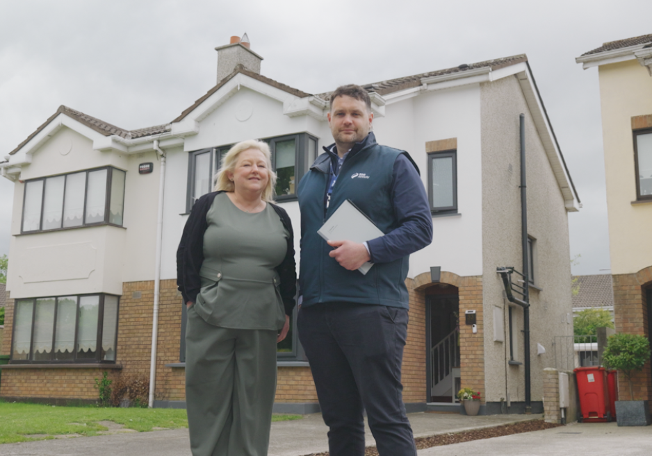 Martina standing outside her home with John from SSE Airtricity
