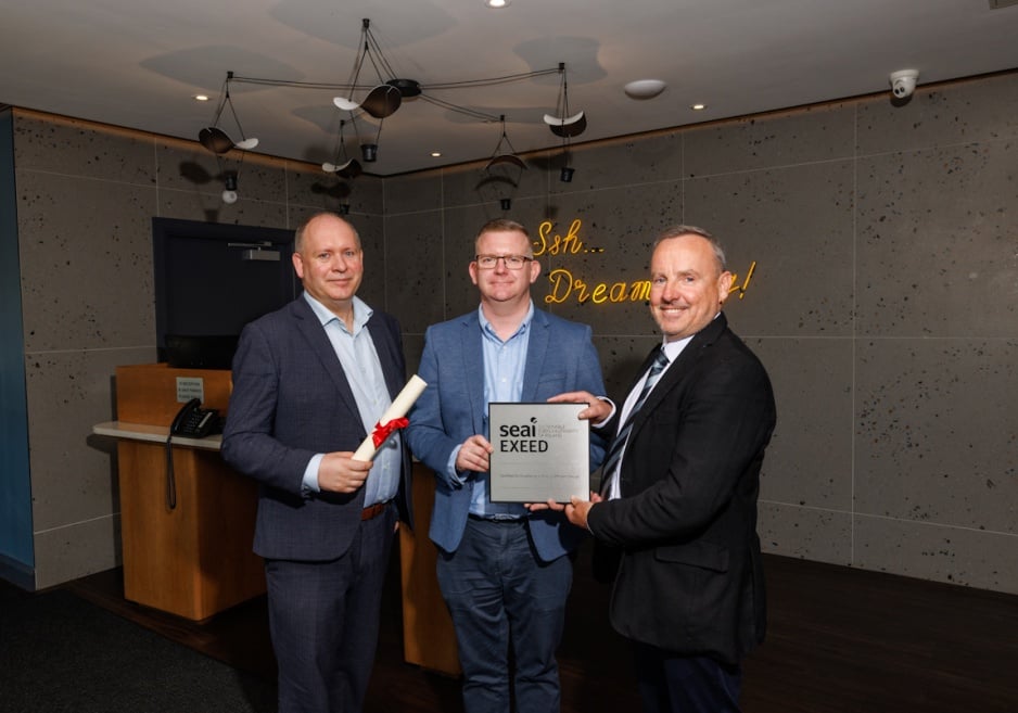 Three people pose with EXEED certification