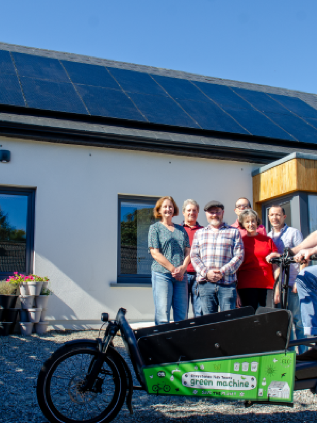 Family outside house with solar pv