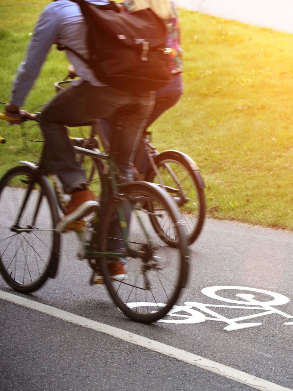 Three people cycling on a cycle path