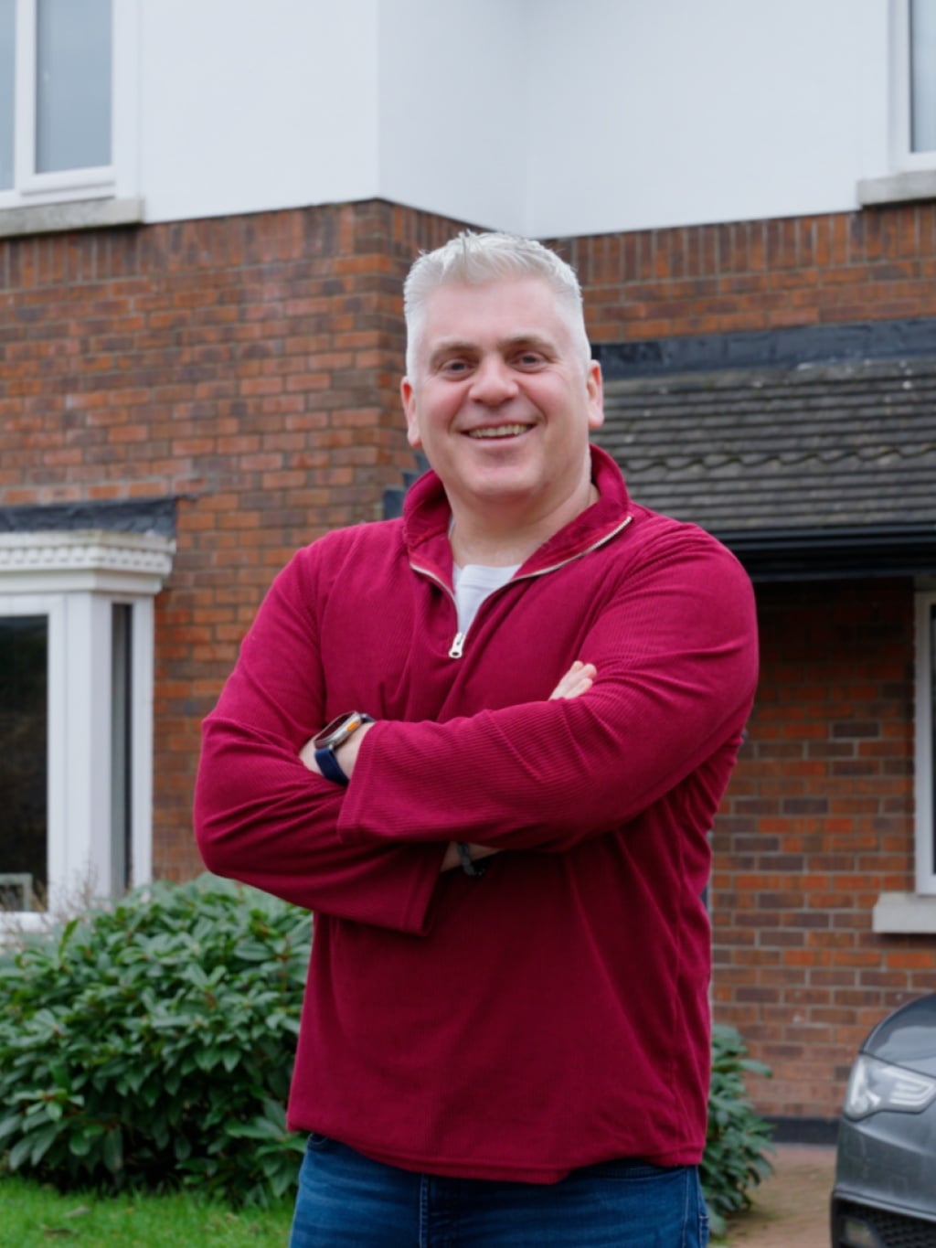 Man standing outside of his house