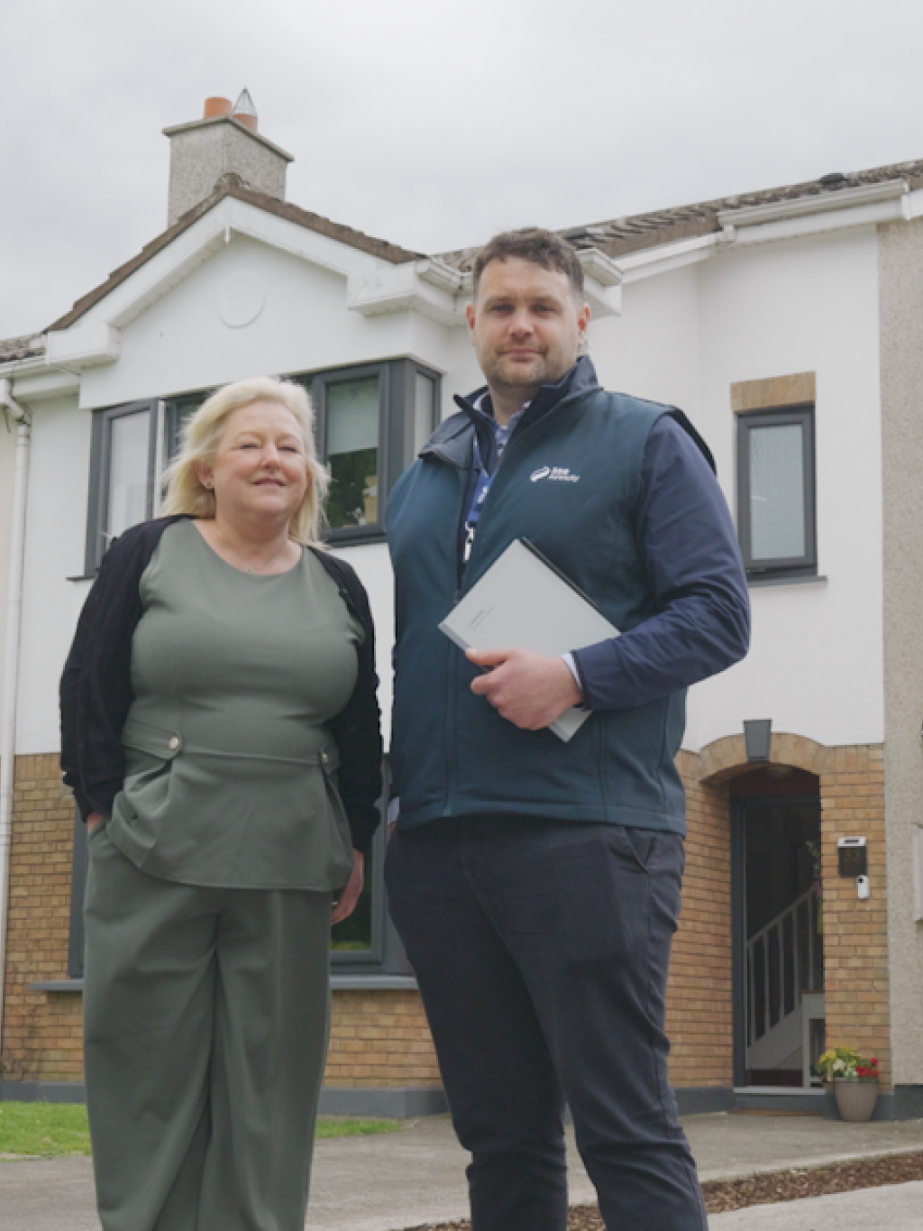 Martina standing outside her home with John from SSE Airtricity