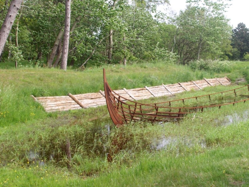 A wooden boat structure in a field