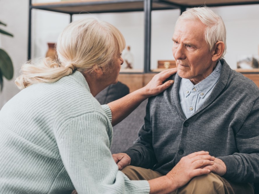 A woman caring for an elderly man