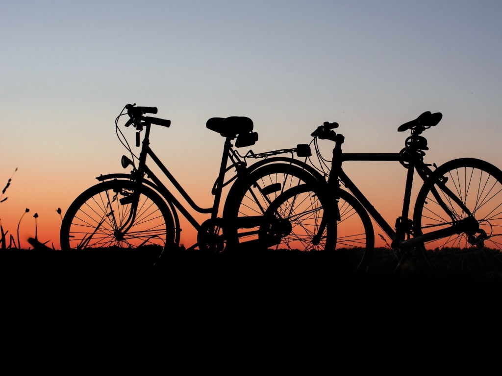 2 bicycles in front of a sunrise